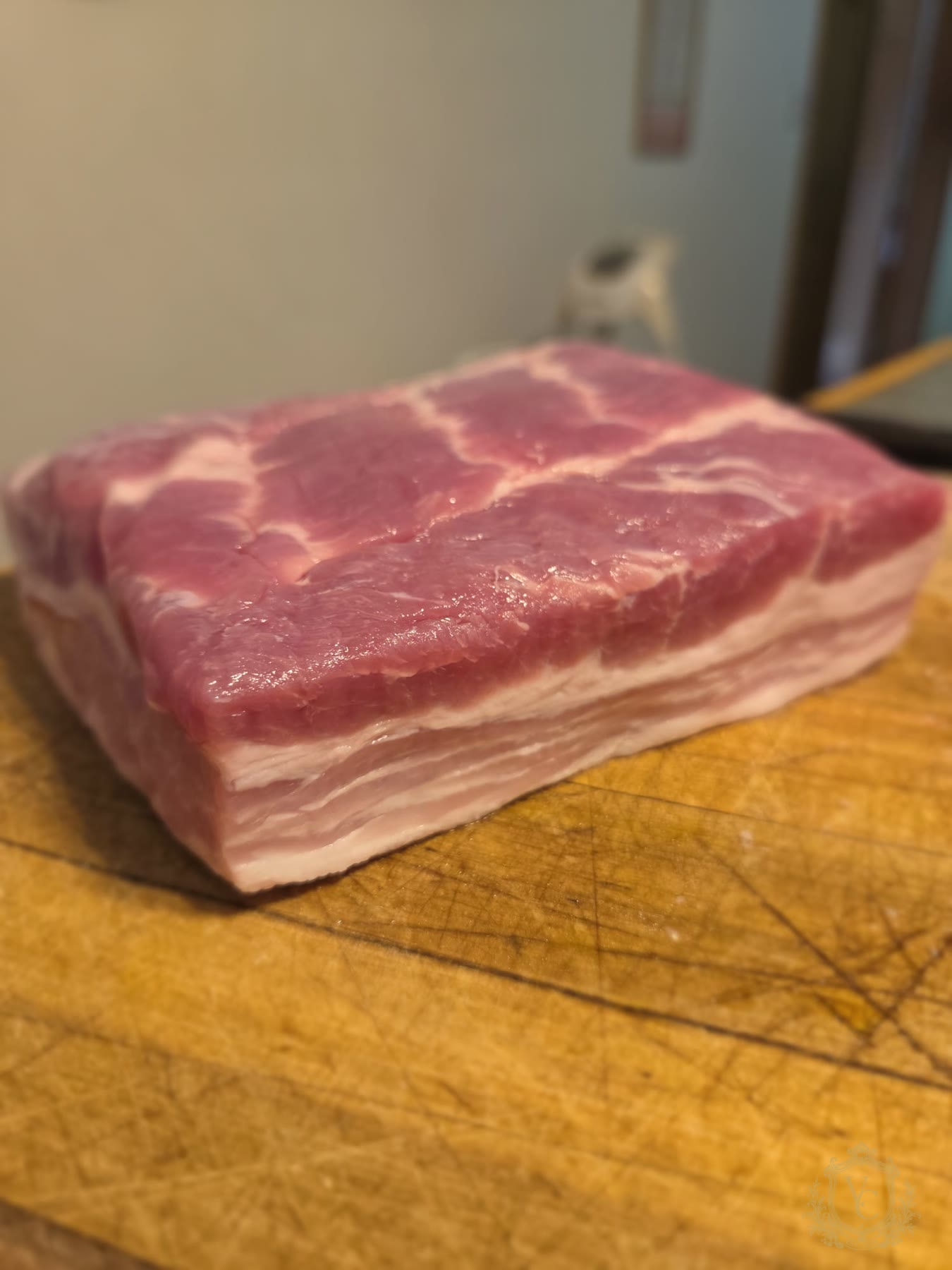 Fresh pork belly showing meat and fat layers before Steven Calabrese scores it.